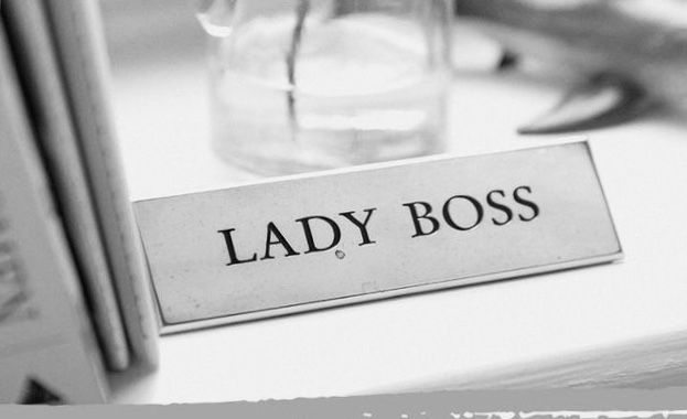 Black and white photo of a tag on a desk that says "lady boss".